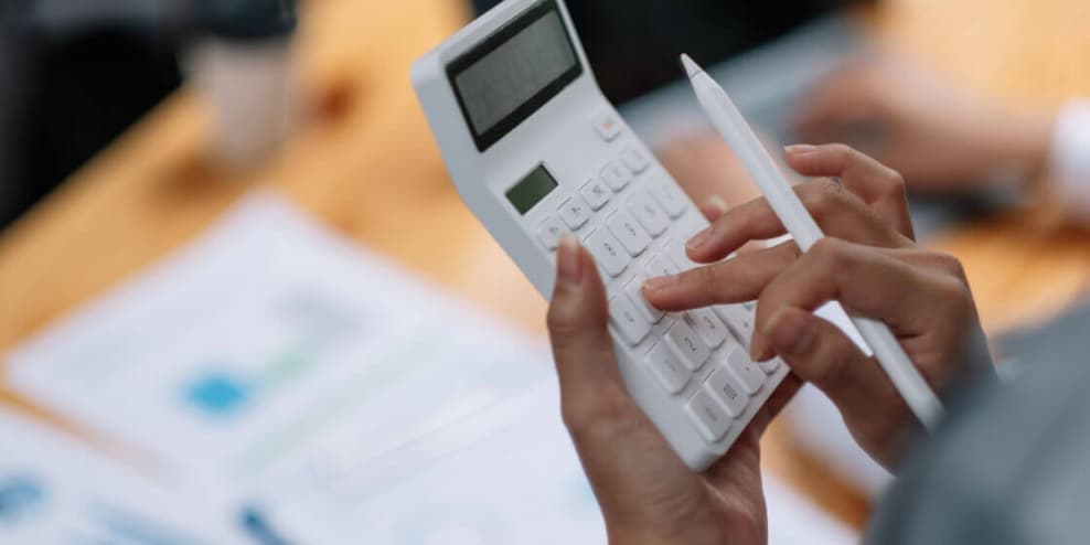 Reviewing financial documents with a calculator